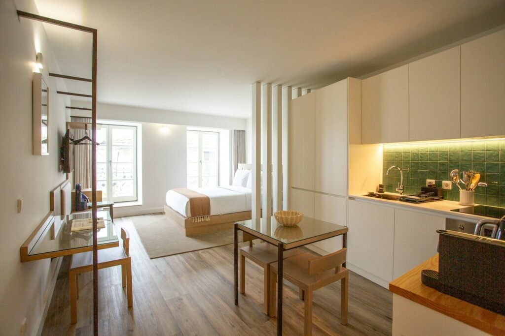 Open bookshelf dividing a studio apartment into living and sleeping areas