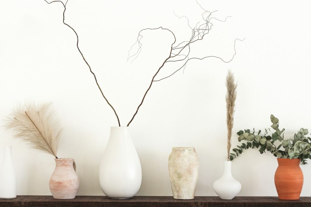 DIY limewash painted vases in neutral tones on a wooden table