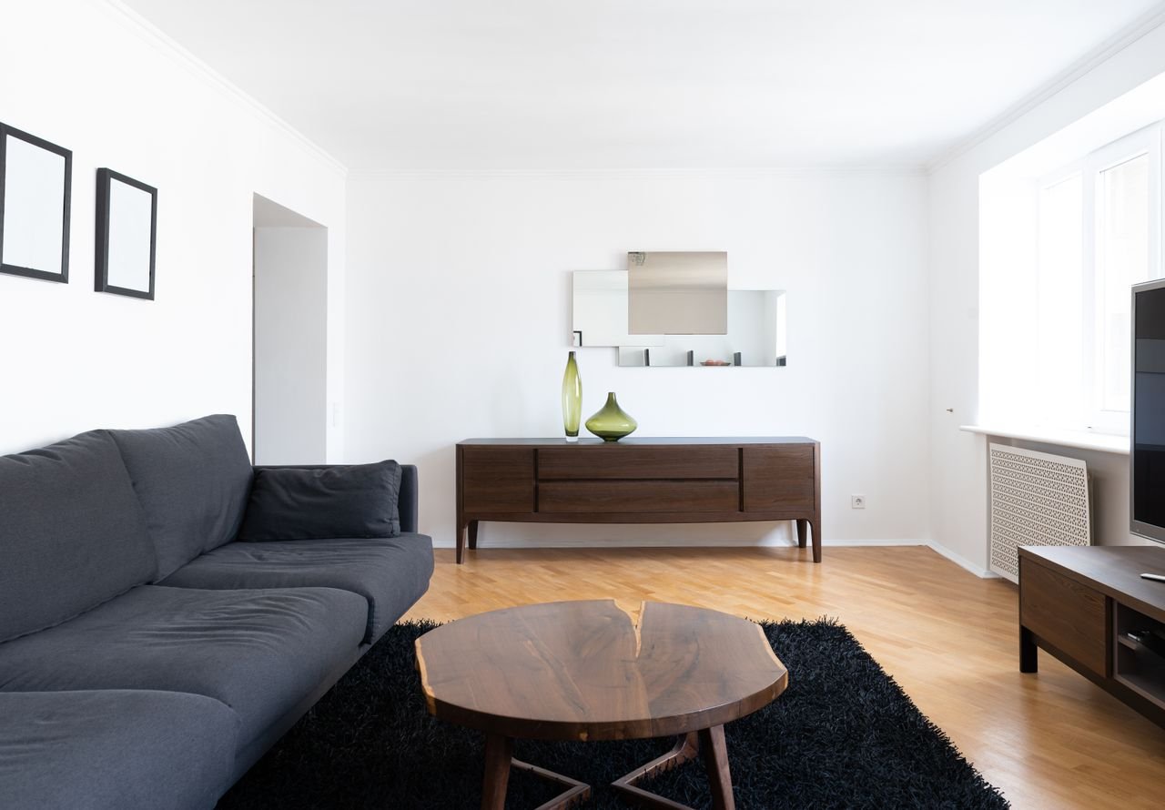 Bright first apartment living room with couch and wooden table
