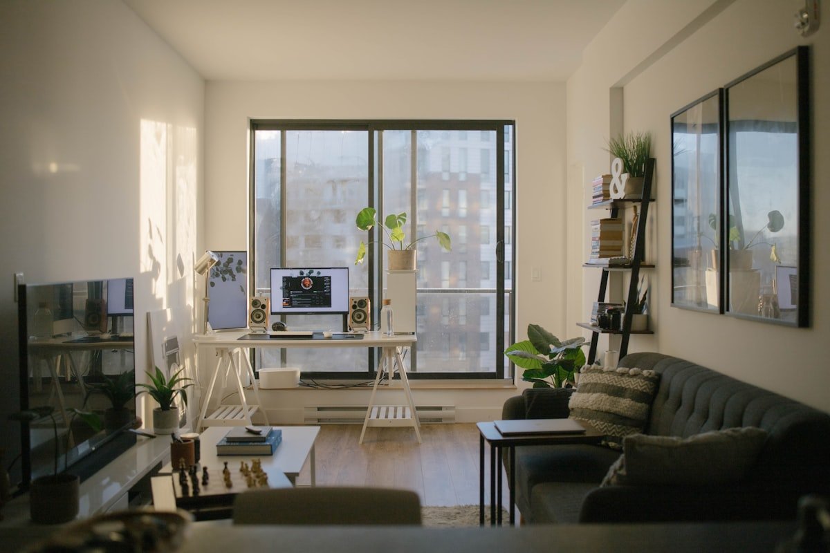 Sunlit first apartment living room with sofa and desk
