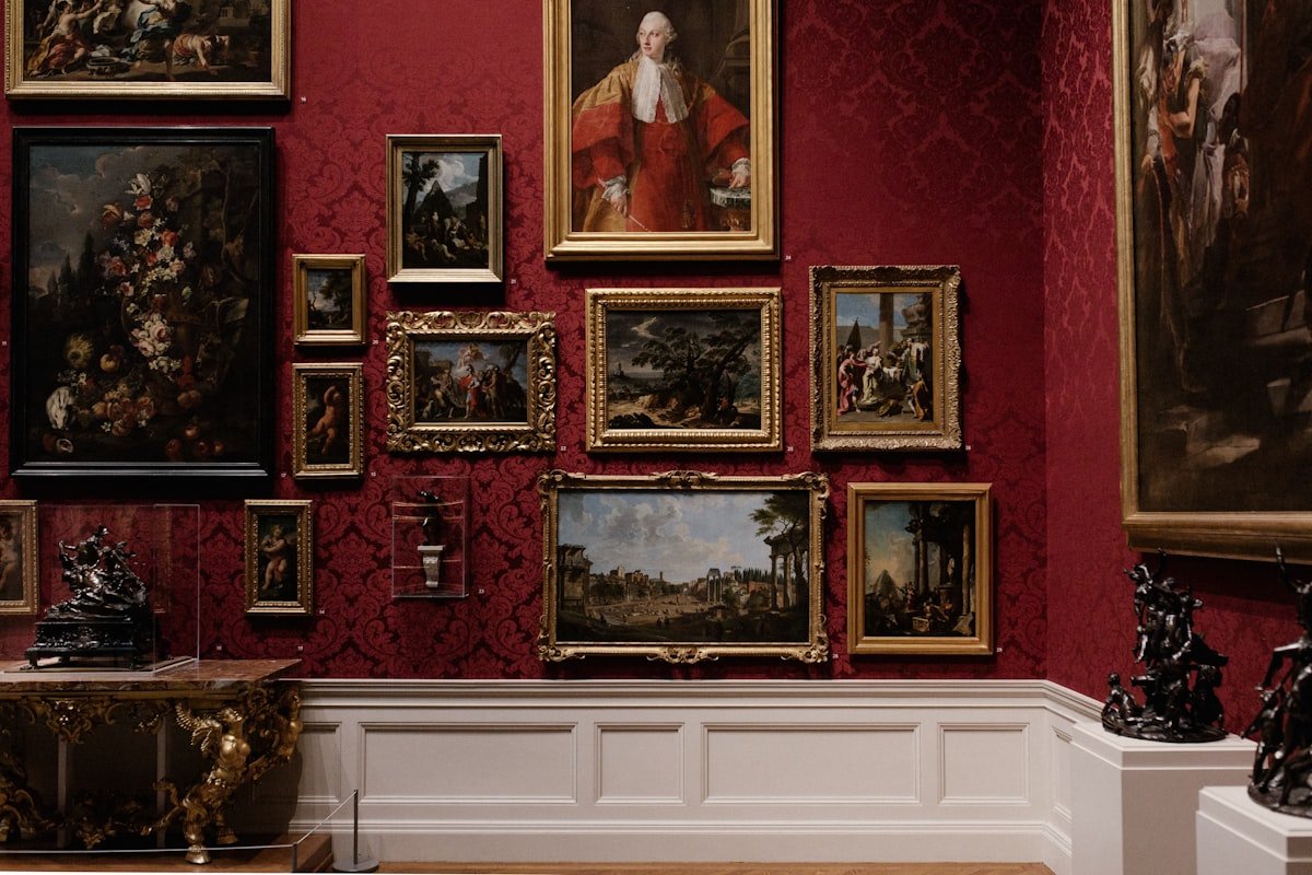Assorted picture frames arranged on a white wall