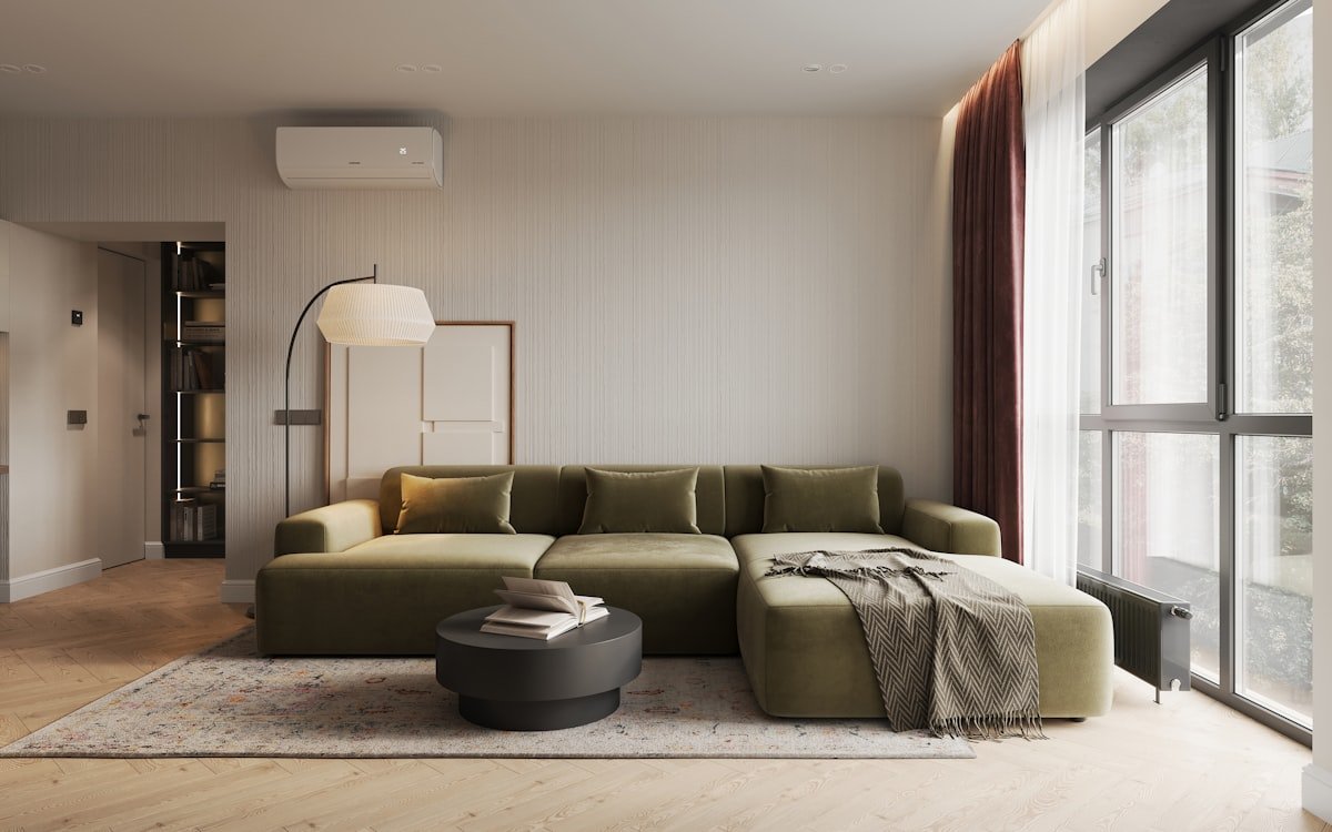 Small living room styled around a statement green sofa
