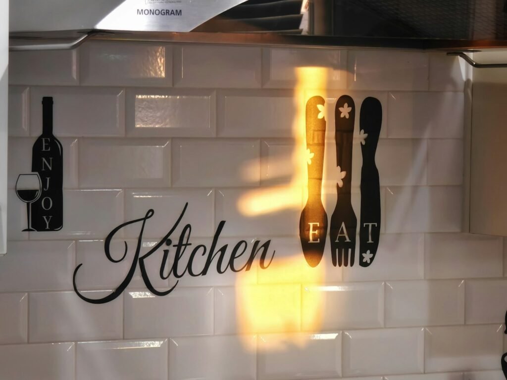 Rental kitchen with white peel-and-stick subway tile backsplash behind the counter