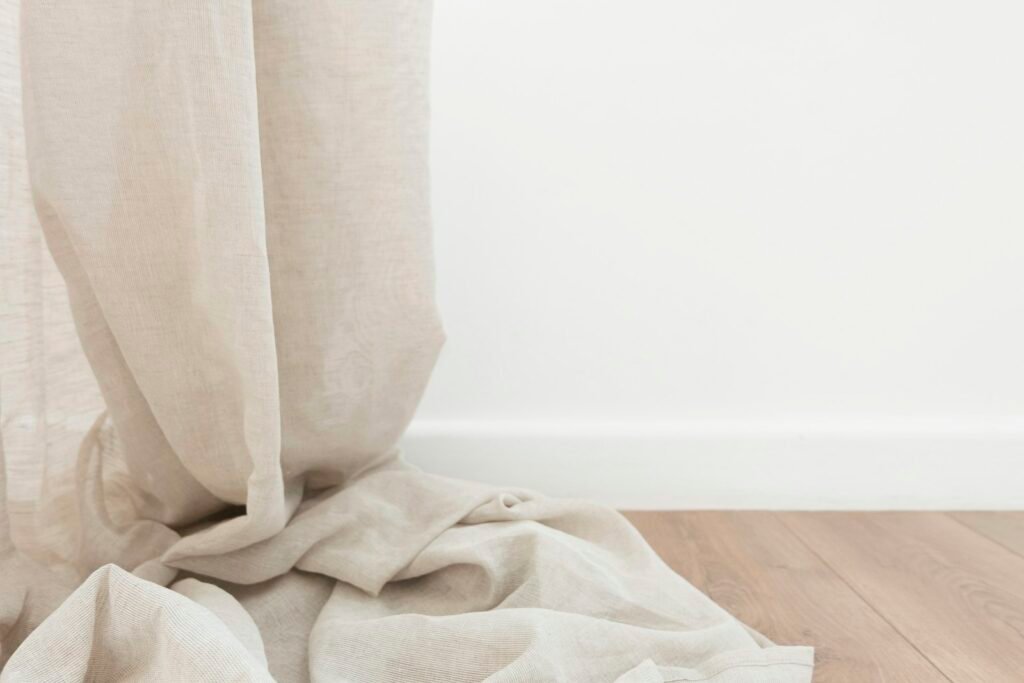 Floor-to-ceiling tension rod with curtain hiding a storage nook in a rental apartment