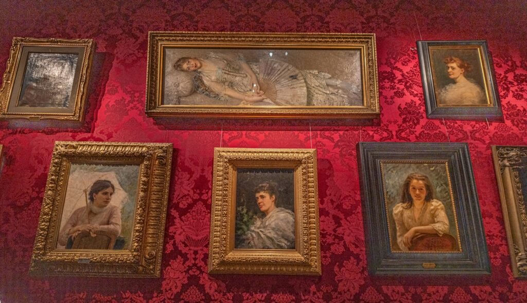 Thrifted vintage oil paintings arranged as an eclectic gallery wall