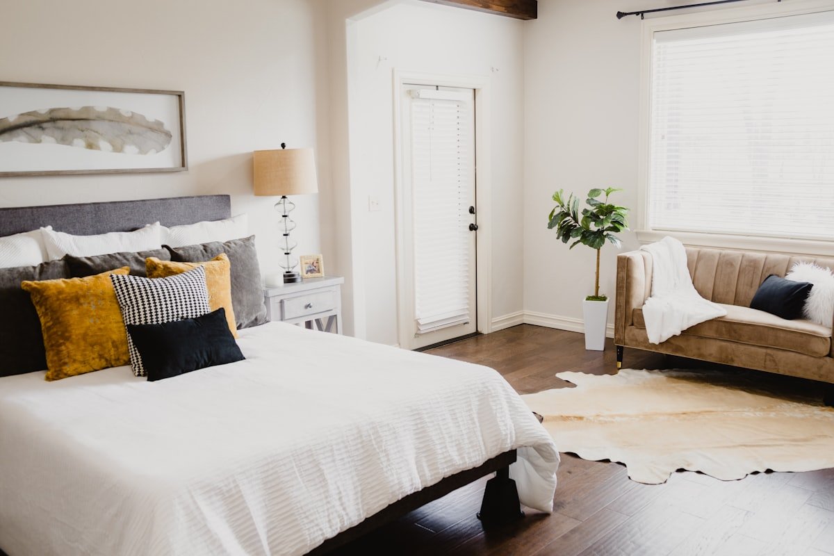 Crisp white bedding in a simple apartment bedroom