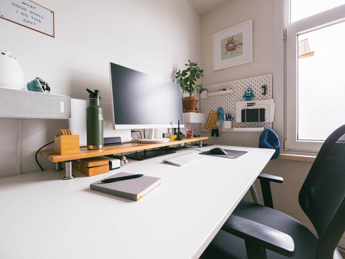Bright white desk workspace in a small apartment