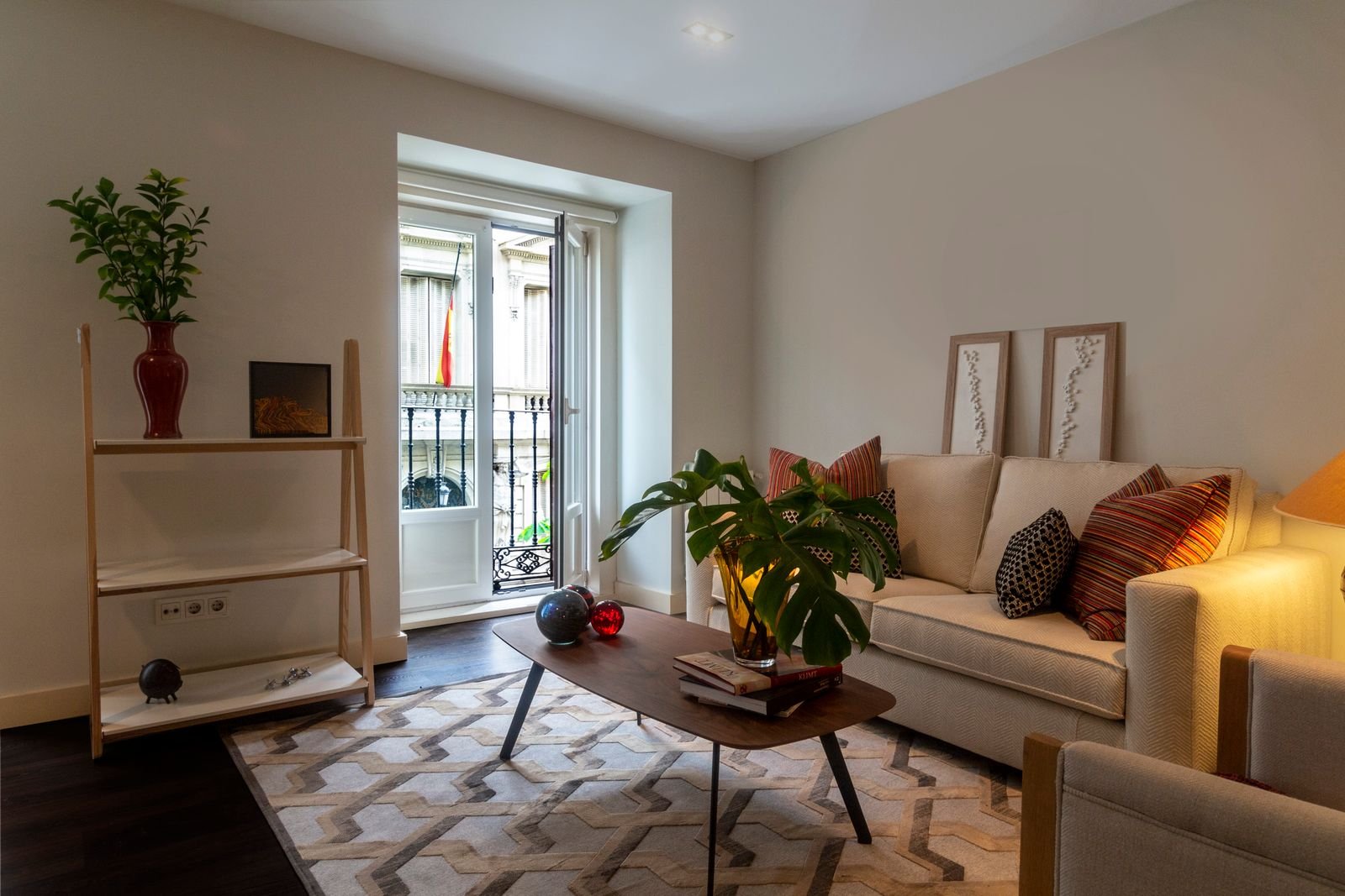 Comfortable sofa with colorful cushions and a coffee table in a small living room