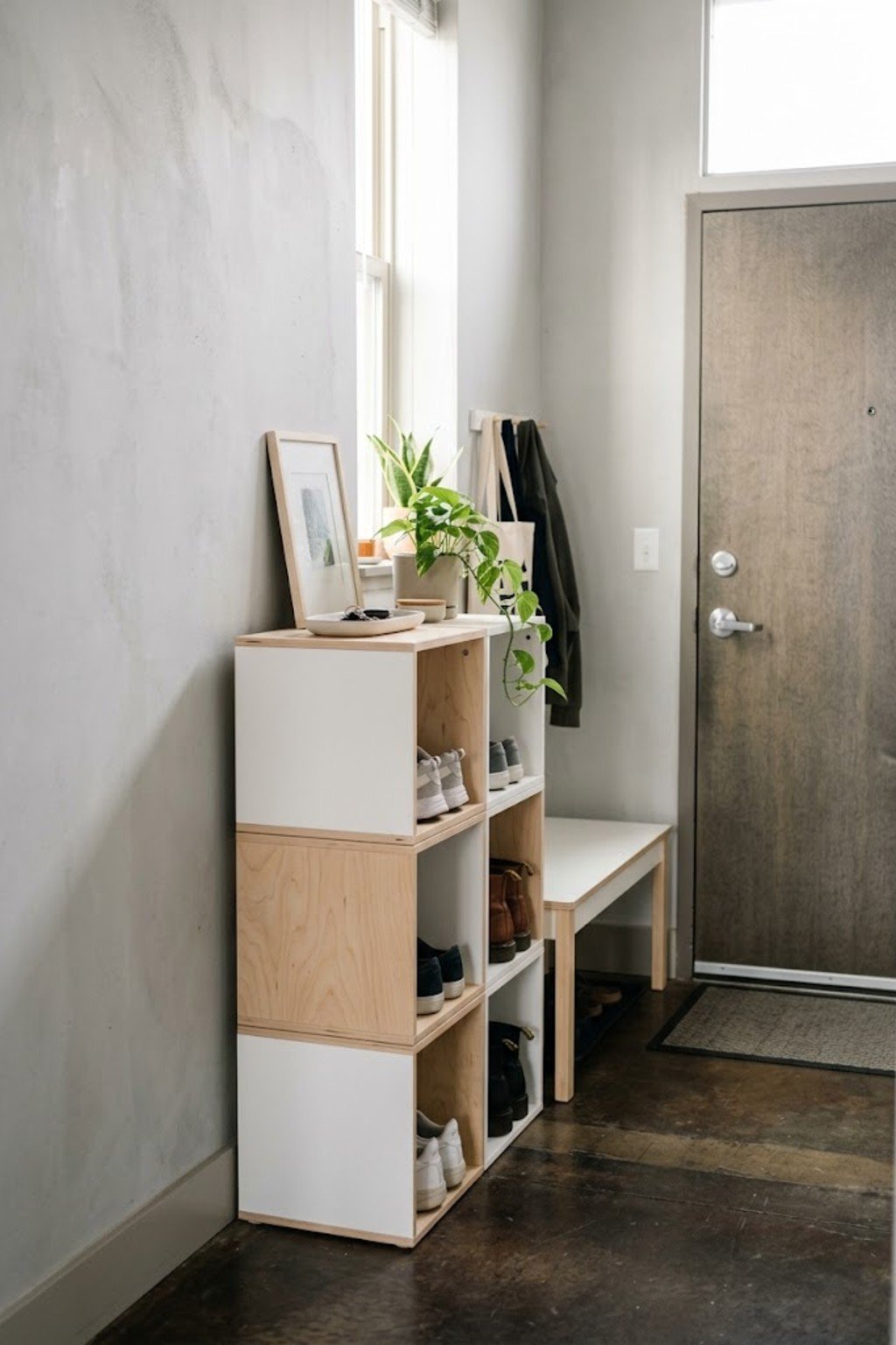 Use stackable cube shelves in a small apartment entryway