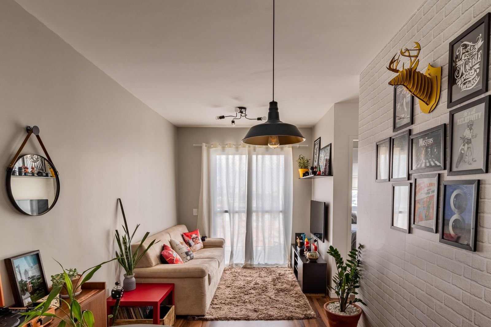 Cozy living room with a gallery wall of framed art hung damage-free