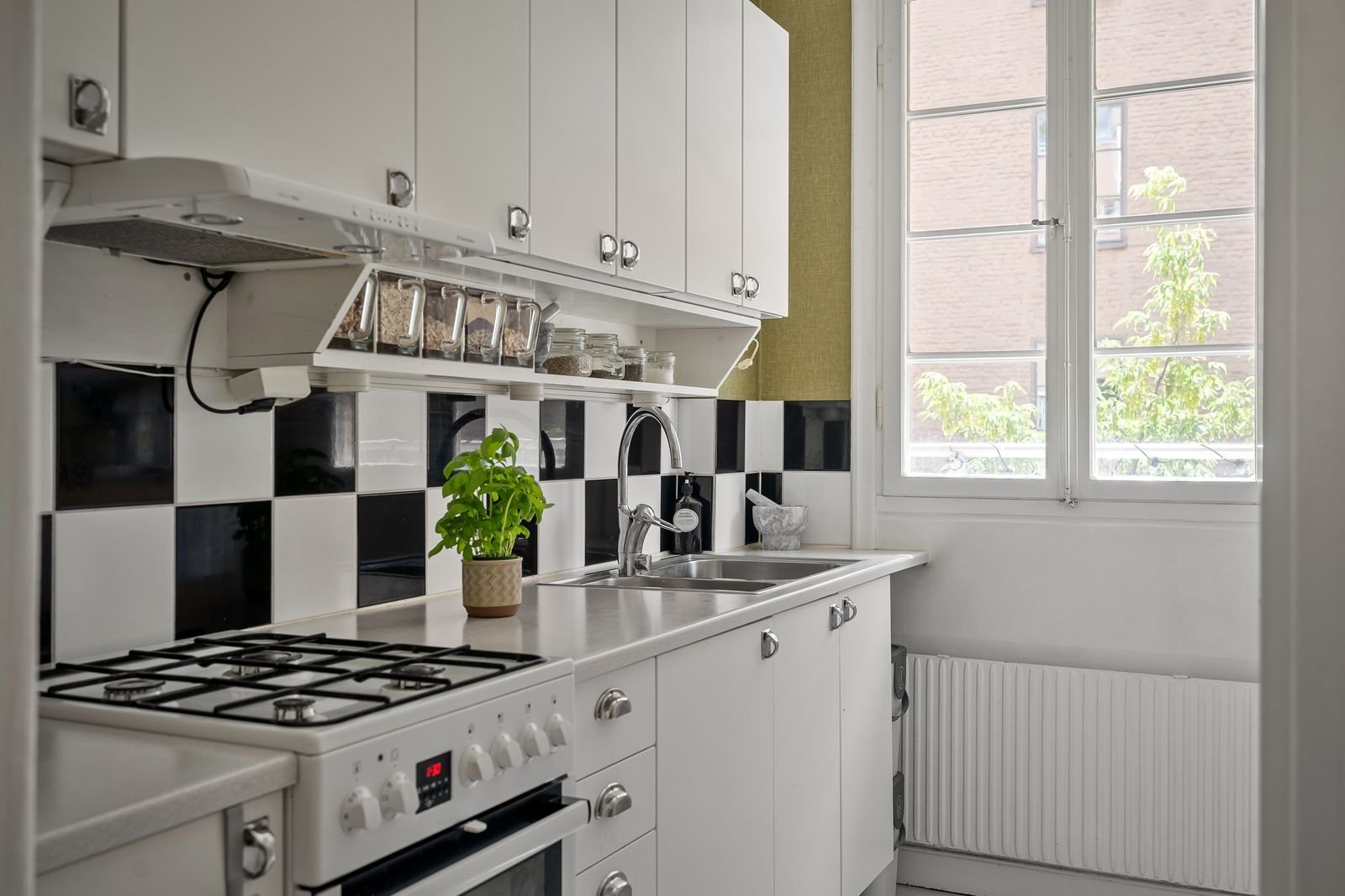 Narrow small apartment kitchen with simple upgrades and a checkered tile backsplash