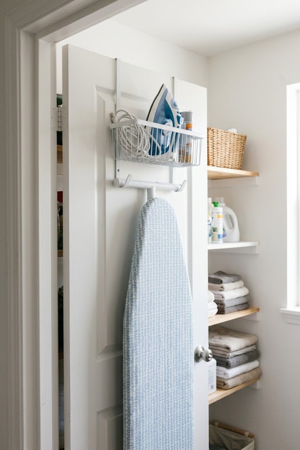 Ironing board and iron stored on an over-the-door holder