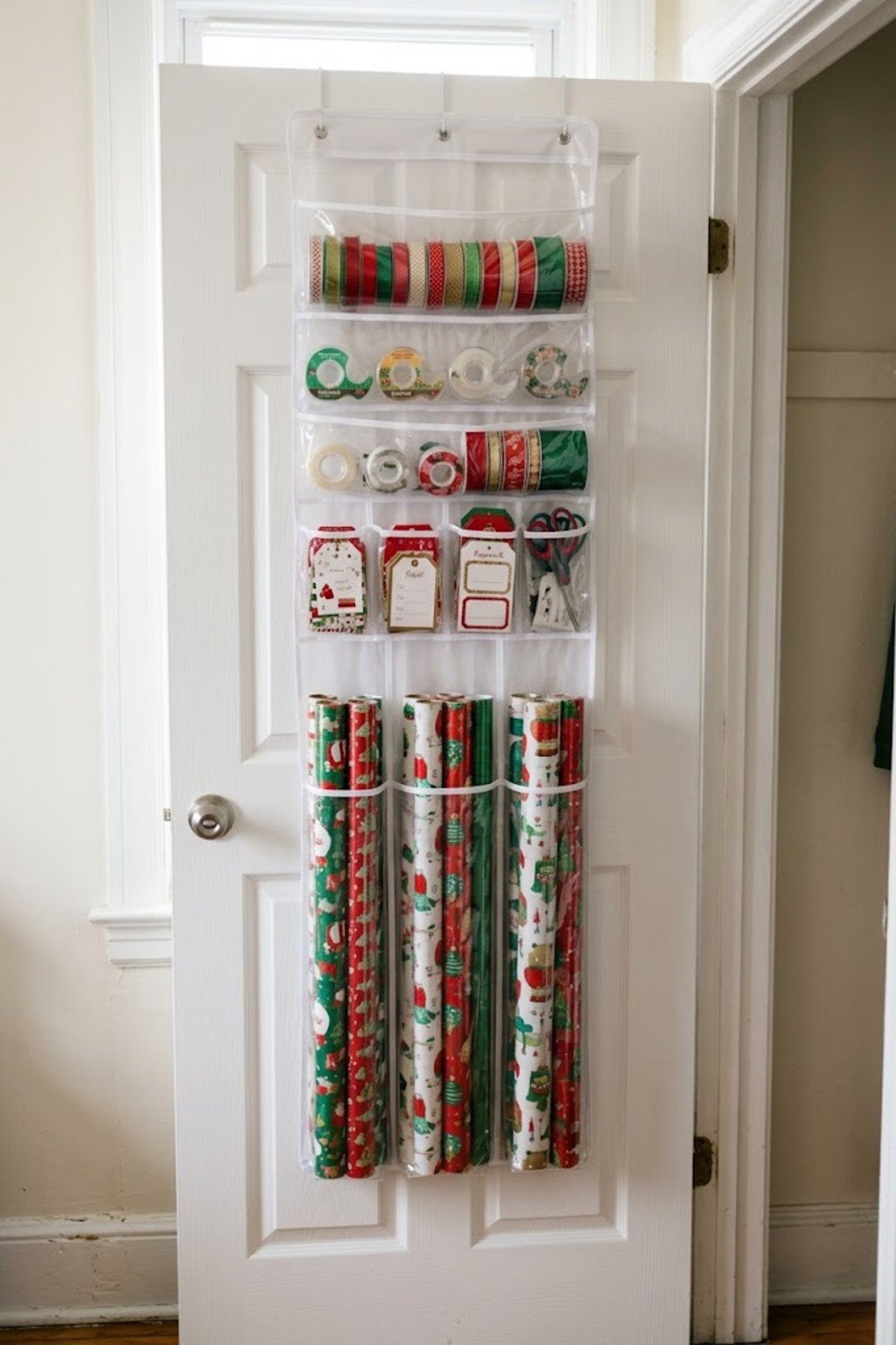 Over-the-door organizer holding wrapping paper and ribbon