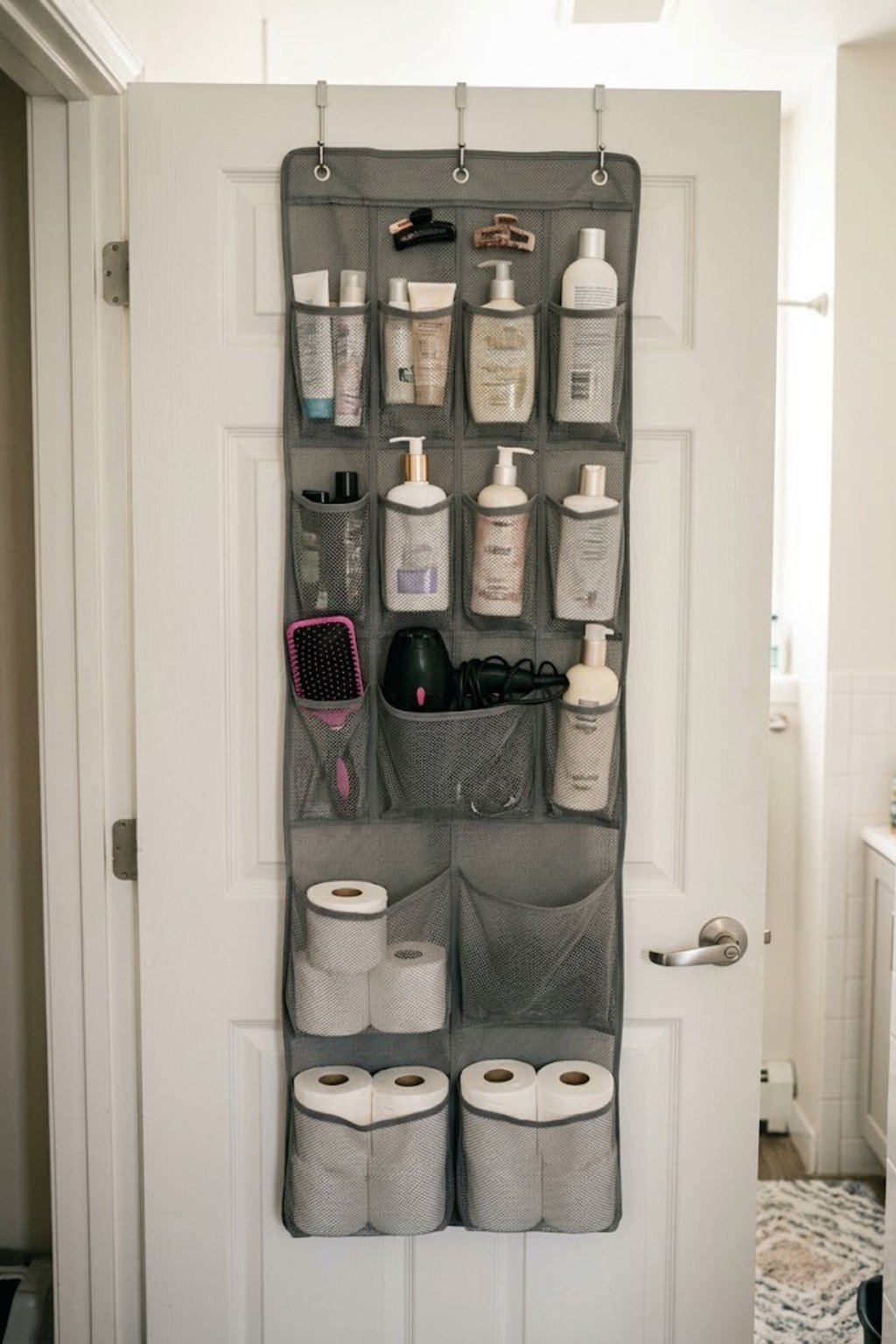 Mesh over-the-door organizer with toiletries on a bathroom door