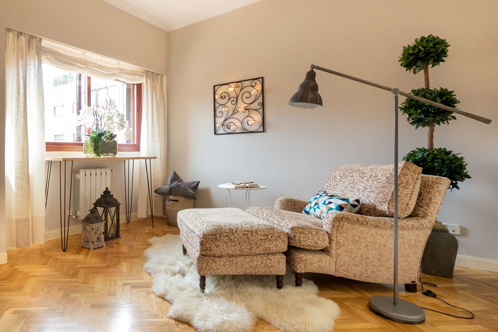 Cozy reading corner with armchair, floor lamp and soft rug in a rental