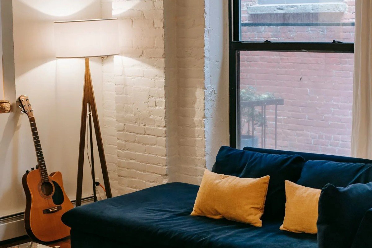Cozy rental living room with colorful cushions and simple decor