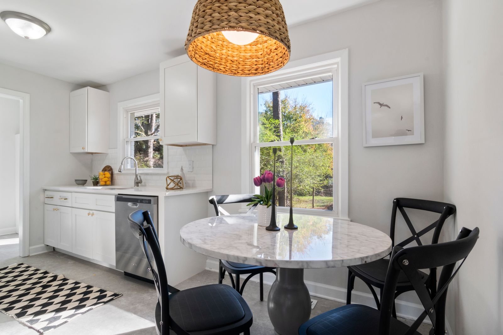 Small kitchen with a round table and chairs by the window