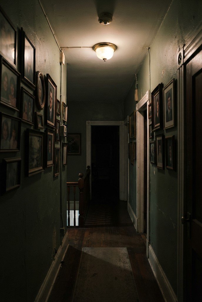 Dark hallway with a flickering light fixture